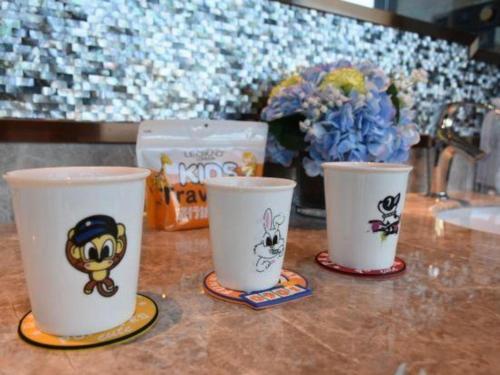 three cups sitting on top of a table with flowers at Dali Hotel in Dali