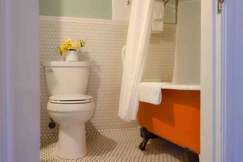 a bathroom with a toilet and a sink at Cabernet House, an Old World Inn in Napa