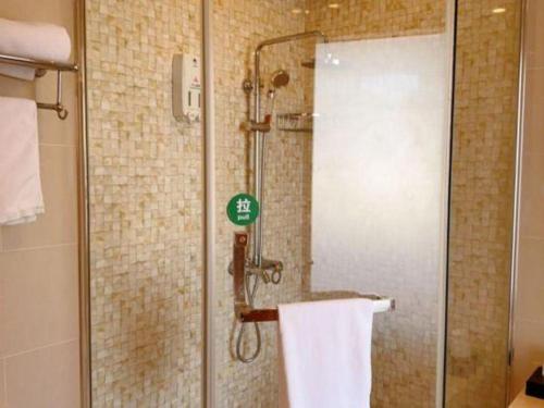 a shower with a glass door in a bathroom at GreenTree Inn Shanghai Fengxian District Xiaotang Metro Station in Shanghai