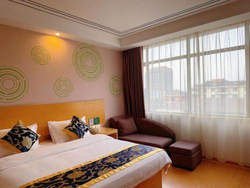 a hotel room with a bed and a chair and a window at GreenTree Inn Shanghai Fengxian District Xiaotang Metro Station in Shanghai