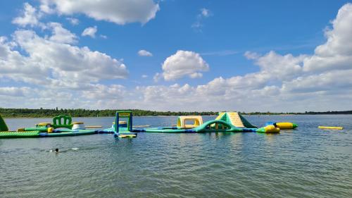 a group of inflatable play equipment in the water at Ferienhaus am Schladitzer See Leipzig Messe Flughafen in Schkeuditz