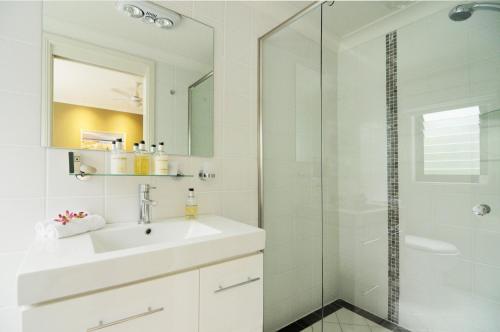 a white bathroom with a sink and a shower at CeeSpray - Accommodation in Huskisson - Jervis Bay in Huskisson