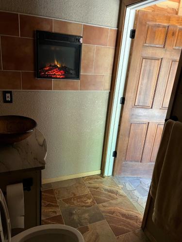 a room with a fireplace next to a door at Priv Hidden retreat ATV trails spa fishing outdoor activities in Jefferson