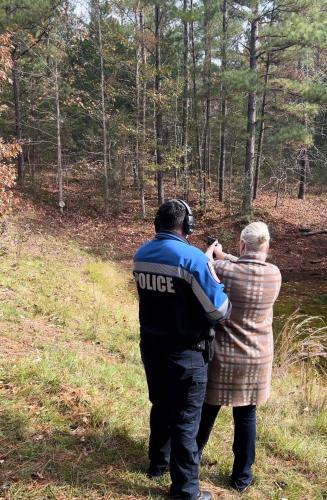 a police officer standing next to a woman in a field at Priv Hidden retreat ATV trails spa fishing outdoor activities in Jefferson