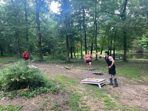 a group of people playing with a frisbee in a field at Priv Hidden retreat ATV trails spa fishing outdoor activities in Jefferson