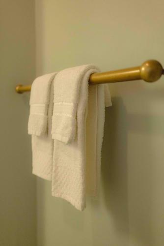 a group of white towels hanging on a towel rack at Cabernet House, an Old World Inn in Napa