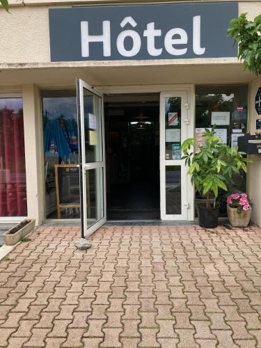 a hotel building with the door open on a patio at HOTEL RESTAURANT Chez Nous in Fitou