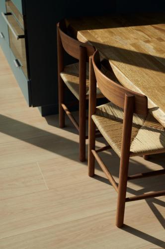 a wooden table with wooden chairs next to a counter at Grend Stavern in Larvik