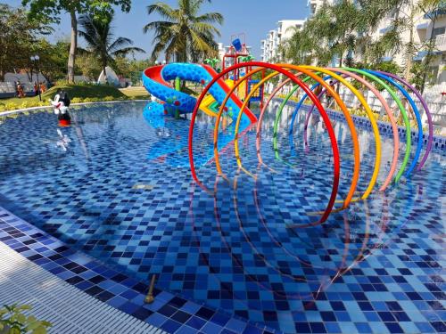 a pool with a water slide in a resort at Santorini Apartments 1D F5 U8 in Negombo