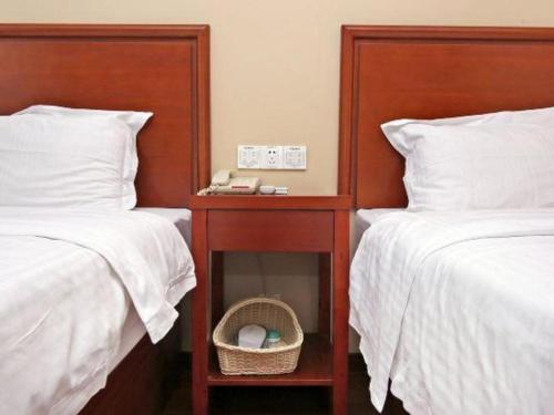 a bedroom with two beds and a table with a mirror at GreenTree Inn Shanghai Hongqiao Airport Huqingping Highway Shell Hotel in Shanghai