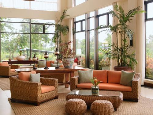 a living room with couches and tables and windows at Hotel Kimberly Tagaytay in Tagaytay