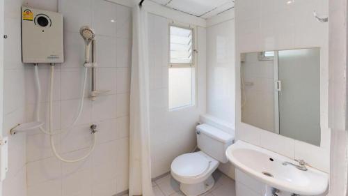 a white bathroom with a toilet and a sink at BR Hotel & Residence (Parking is available 250 meters away from the property) in Ban Rong Khoei