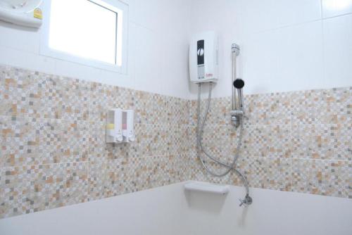 a shower in the corner of a bathroom at Pearl By The Sea Resort in Prachuap Khiri Khan