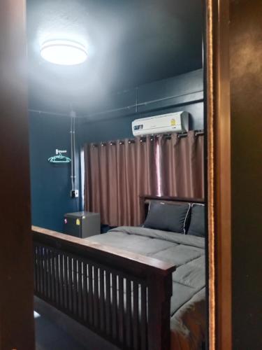 a mirror reflection of a bed in a room at HiSSS Style ชะอำ in Cha Am
