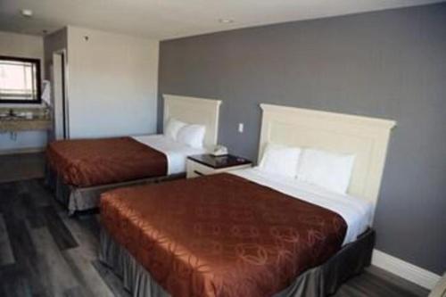 a hotel room with two beds in a room at Grand Park Inn in Baldwin Park