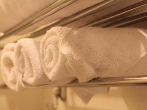 a white towel on a towel rack in a bathroom at Midland Hotel in Phnom Penh