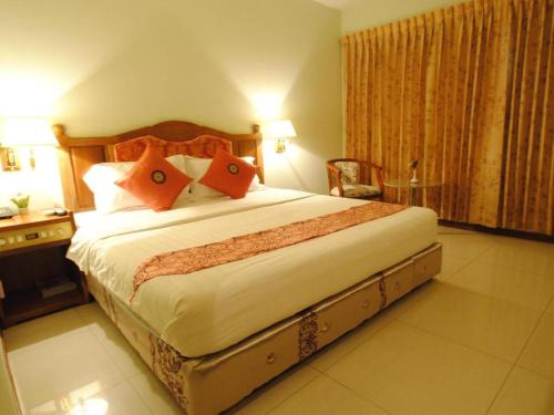 a bedroom with a large bed in a hotel room at Midland Hotel in Phnom Penh
