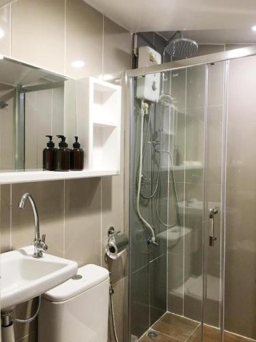 a bathroom with a shower and a toilet and a sink at THE GOOSE HOUSE UBON in Ubon Ratchathani