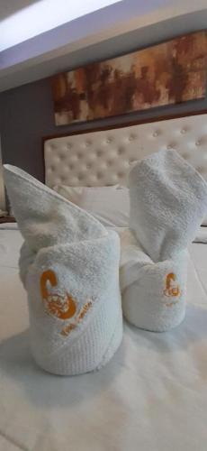 two folded towels sitting on top of a bed at Hotel Camila 2 in Dipolog