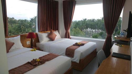 Giường trong phòng chung tại Damina boutique hotel