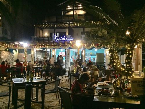 a group of people sitting at a restaurant at night at Residencia Boracay in Boracay
