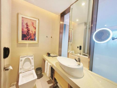a bathroom with a sink and a toilet at Lavande Hotel·Dongxing Port in Fangcheng