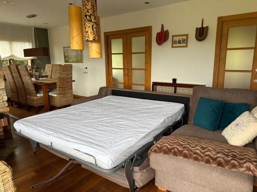 a bed in a room with a couch and a table at Finca Gonzalez in Deva