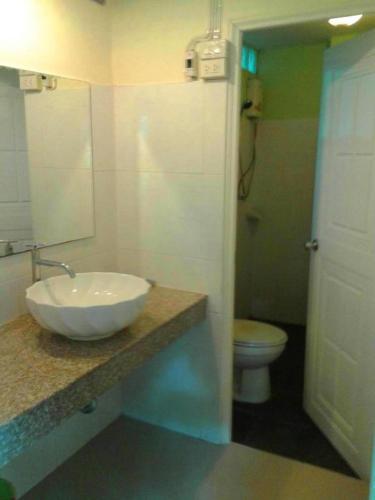 a bathroom with a sink and a toilet at At Home Suanphung in Ratchaburi