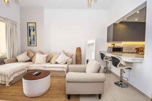 a living room with a couch and a table at Serene Lagoon Escape in Ras al Khaimah