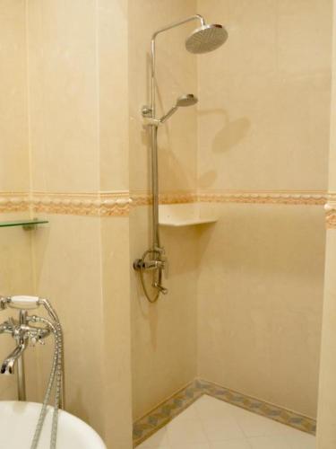 a shower stall in a bathroom with a toilet at The View Pavilion Hotel in Luang Prabang