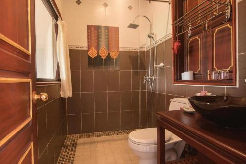a bathroom with a toilet and a sink at The View Pavilion Hotel in Luang Prabang