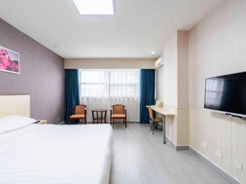 a hotel room with a bed and a desk and a television at 7 Days Inn Chengdu Huayang Metro Station Binfen Plaza in Chengdu
