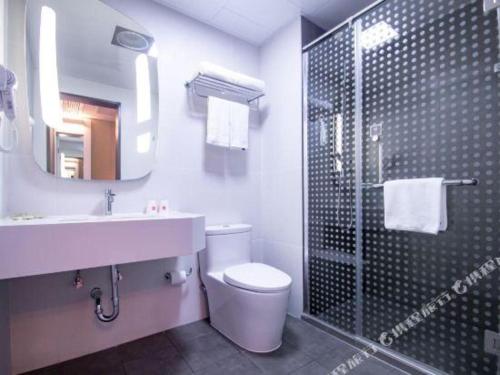 ein Badezimmer mit Toilette, Waschbecken und Dusche in der Unterkunft Hanting Hotel Wuxi Taihu Lake Plaza Branch in Wuxi