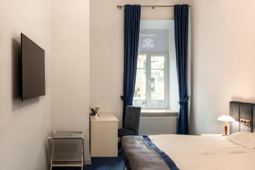 a bedroom with a bed and a window at Metro Hotel Apartments in Odesa