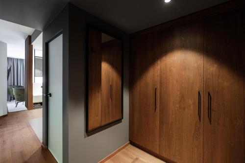 a hallway with wooden cabinets and a mirror at Hotel Alte Post Südsteiermark in Leibnitz