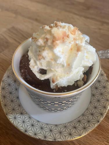 a bowl of ice cream on a plate at Chambres d'Hôtes Belle Vallee in Domfront
