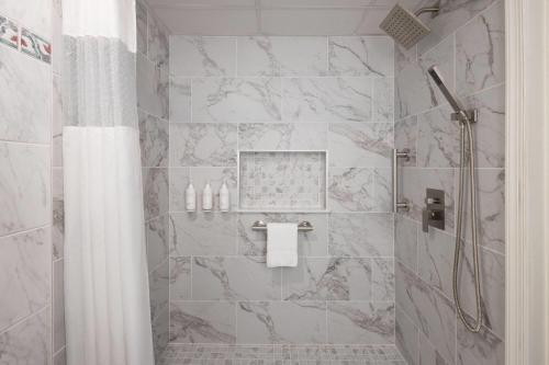 a bathroom with a shower with a shower curtain at Howard Johnson Plaza by Wyndham Ocean City Oceanfront in Ocean City