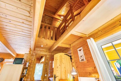 a cabin with wooden walls and ceiling with a refrigerator at Haus Miriam in Walchum