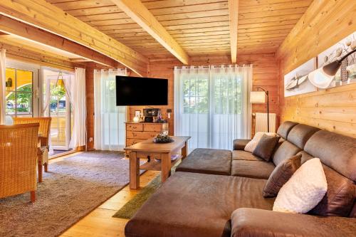 a living room with a couch and a flat screen tv at Haus Miriam in Walchum