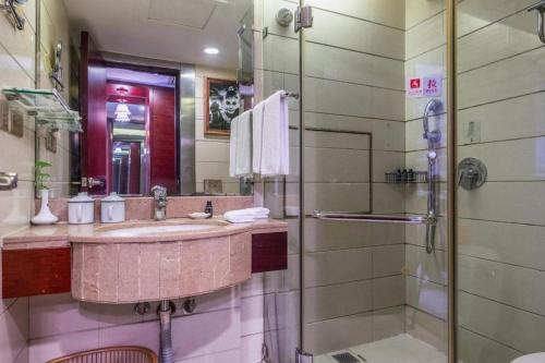 a bathroom with a sink and a shower at Changsha Huatian Hotel in Changsha
