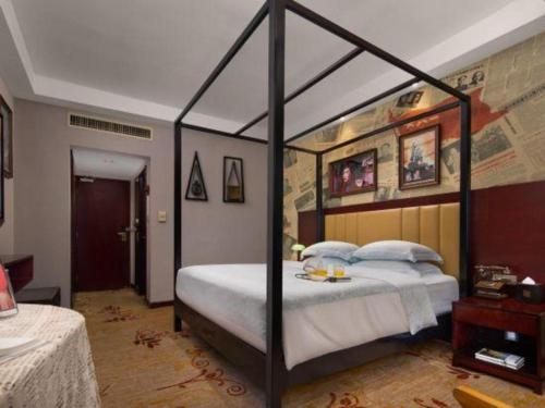 a bedroom with a canopy bed in a room at Changsha Huatian Hotel in Changsha
