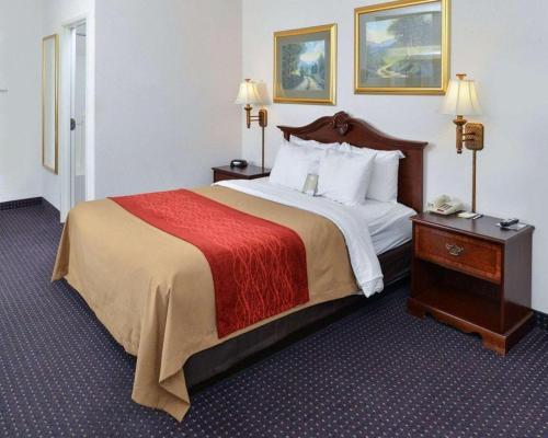 a hotel room with a large bed and a telephone at Comfort Inn & Suites in Riverton