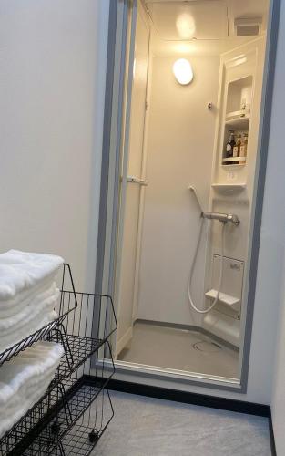 a bathroom with a shower with a glass door at guest house B in Osaka