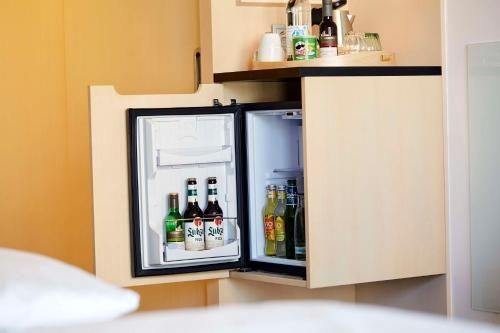 an open refrigerator with drinks inside of it at Scandic Berlin Potsdamer Platz in Berlin