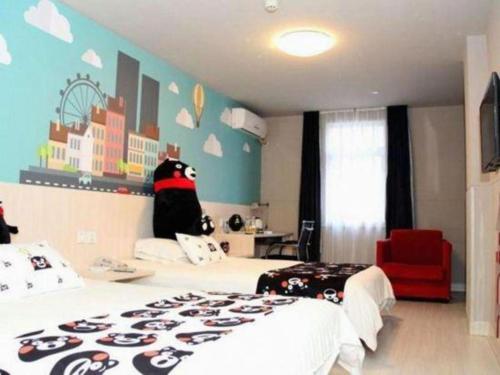 a bedroom with a bed with a hello kitty mural on the wall at Jinjiang Inn Changchun Xi An Avenue Branch in Changchun