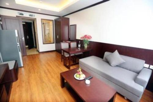 a living room with a couch and a table at Lenid Hotel Tho Nhuom in Hanoi