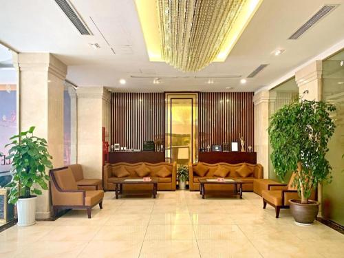 a lobby with couches and chairs in a building at Lenid Hotel Tho Nhuom in Hanoi