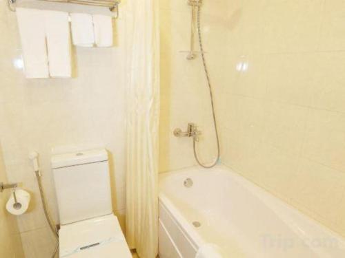 a white bathroom with a tub and a shower at Lenid Hotel Tho Nhuom in Hanoi