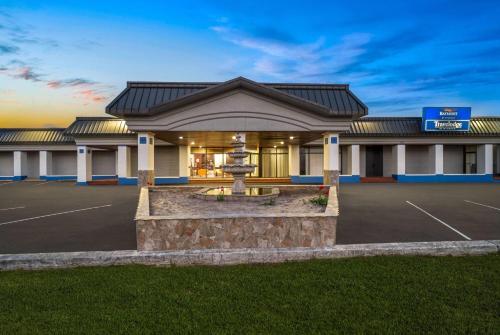a building with a fountain in a parking lot at Baymont by Wyndham Salisbury MD in Salisbury
