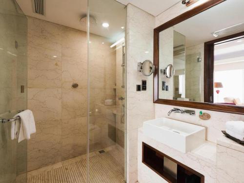 a bathroom with a sink and a shower at Inner Mongolia Hotel Forbidden City in Beijing